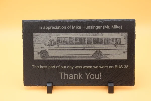 A plaque with an image of a bus on it.