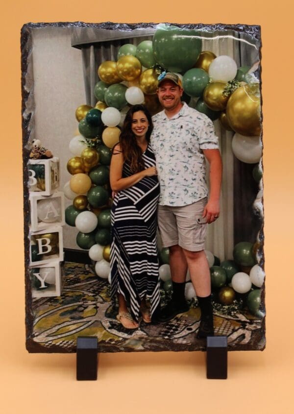 A man and woman standing in front of balloons.