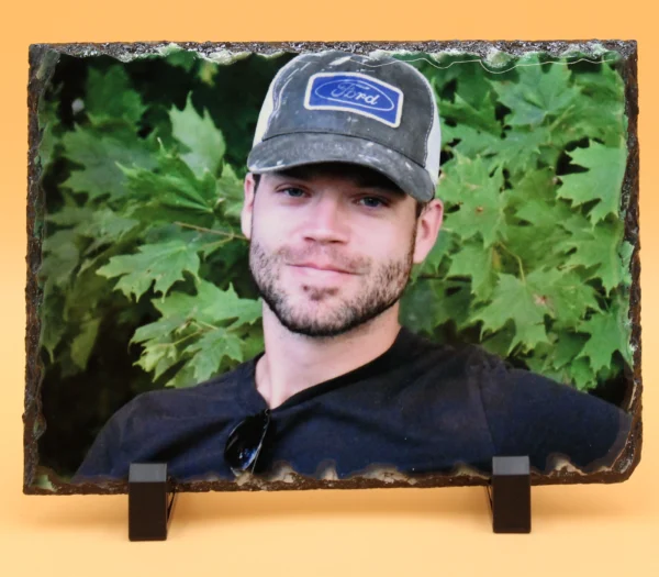 A picture of a man in a hat and black shirt.