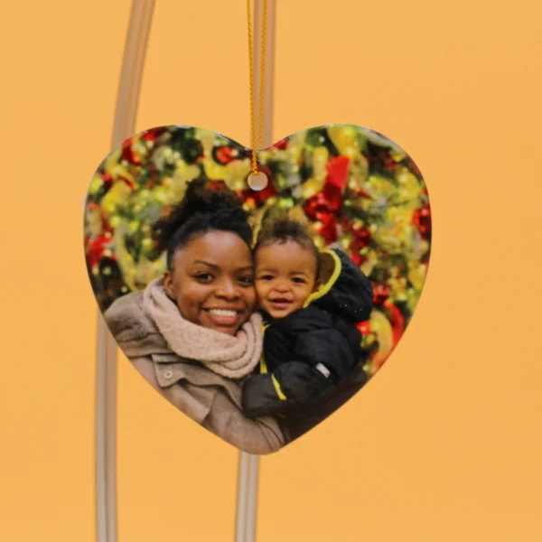 A heart shaped picture frame with a woman and child.