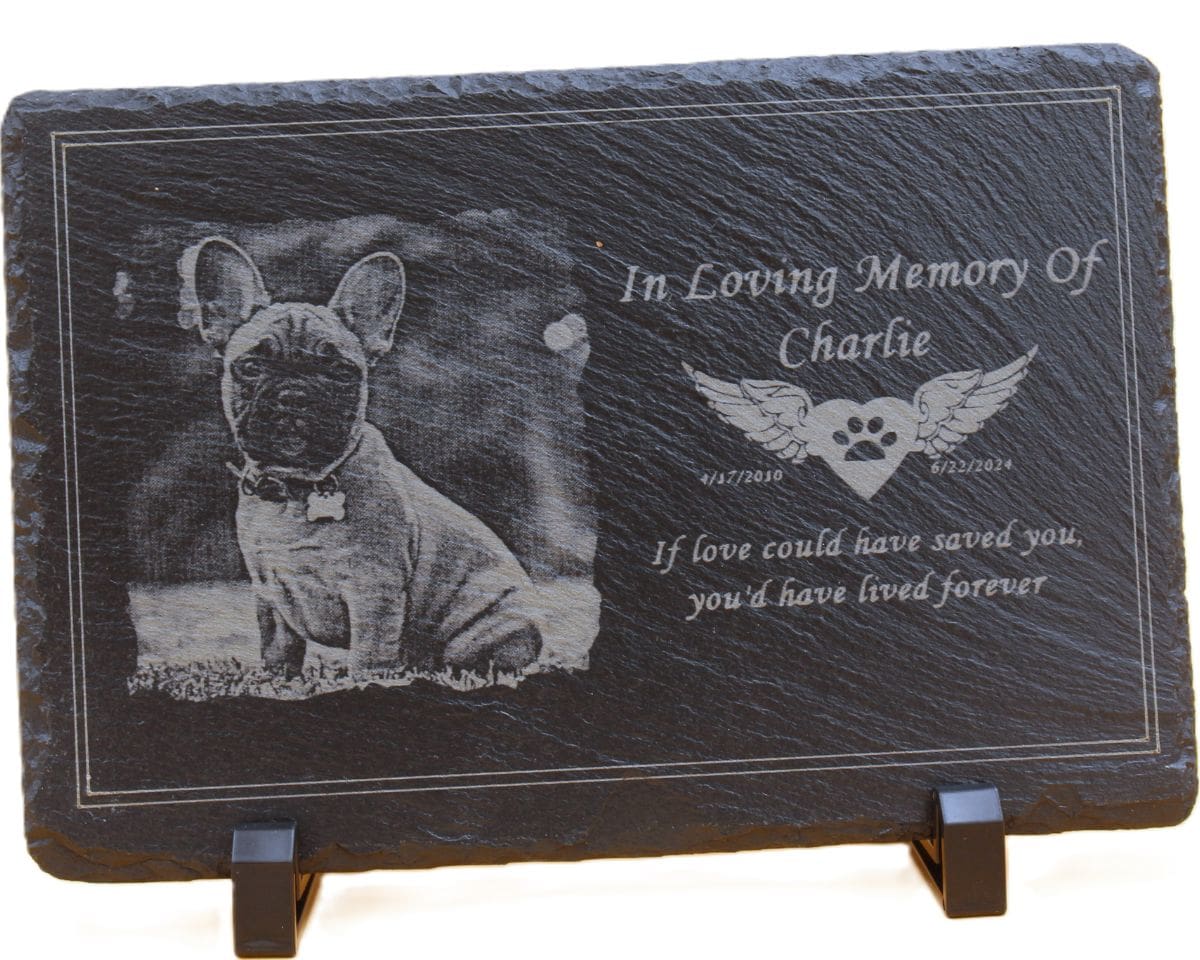 A dog memorial plaque with a picture of a dog.