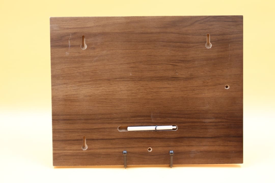 A wooden board with hooks on it