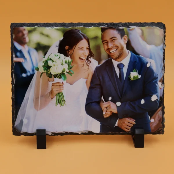 A picture of a newly married couple on a slate.