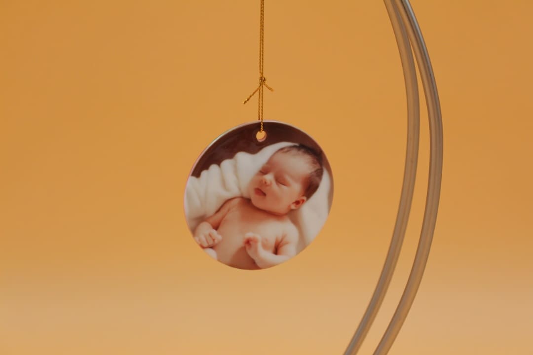 A picture of a baby hanging from a string.